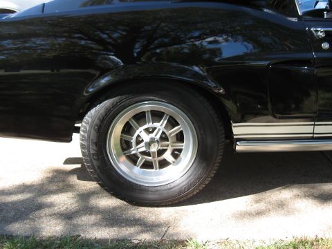 1968 Shelby GT500 - Close-up of the rear wheel and side stripe on a black 1968 Shelby GT500.