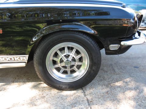 1968 Shelby GT500 - Close-up of the side of a black 1968 Shelby GT500 KR, highlighting its distinctive wheels and badging.