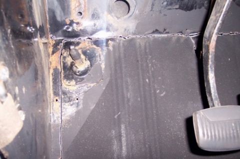 1976 Ford Bronco - The interior floor pan shows significant rust and wear around the pedal assembly.