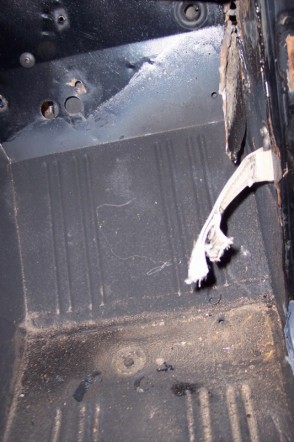 1976 Ford Bronco - Close-up of a vehicle's interior floor pan, showing wear and tear.