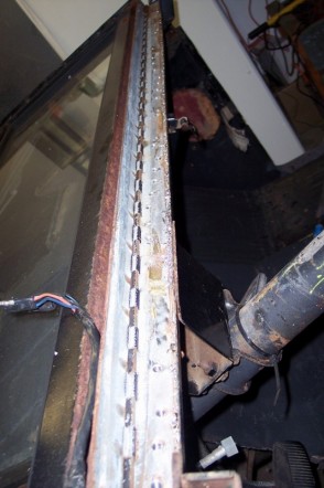 1976 Ford Bronco - This is a close-up of a rusted metal channel with rivets, possibly from a vehicle part.