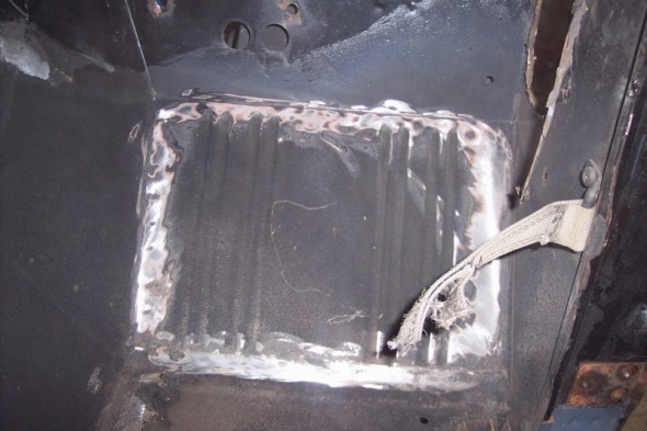 Welded floor pan repair with seatbelt strap