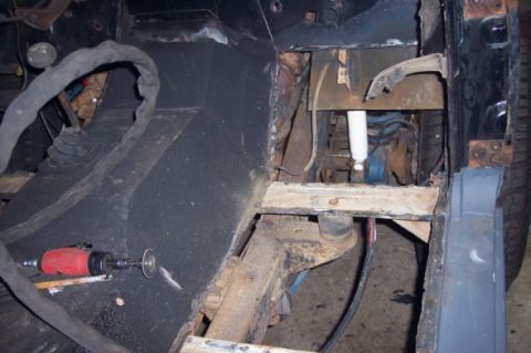 1976 Ford Bronco - This photo shows the underside of a vehicle undergoing repair, focusing on the frame and suspension system.