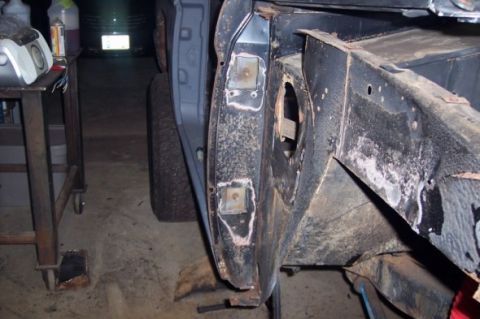 1976 Ford Bronco - Detail of a vehicle's frame and fender area, showing rust and repair patches.