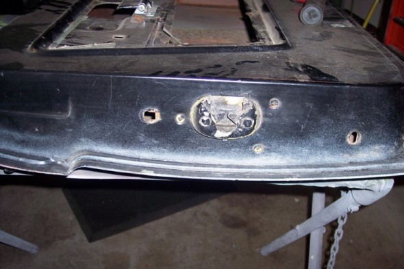 Black tailgate with damaged latch mechanism and mounting holes