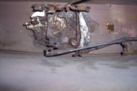 1976 Ford Bronco - Close-up view of a corroded door latch mechanism, likely from an older vehicle.