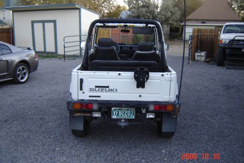 1988 Ford Bronco - Suzuki Samurai rear view showing the tailgate, spare tire carrier, and license plate.