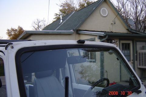 1988 Ford Bronco - Interior of a white SUV with a house in the background. The album claims it is a 1988 Ford Bronco.