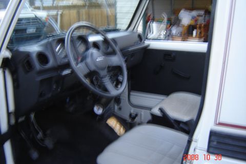 1988 Ford Bronco - Interior view of a Suzuki Samurai, showing the dashboard, steering wheel, and seats.
