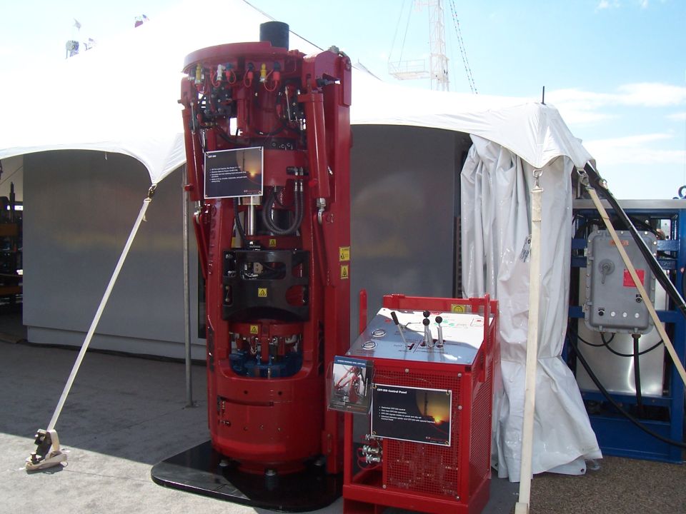 Red industrial drilling equipment with control panel and informational placards