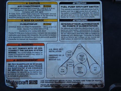 1998 Mercury Grand Marquis - Vehicle labels provide information on air conditioning, fuel pump, and drive belt system components.