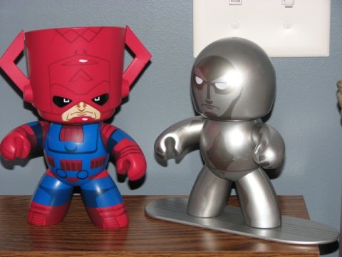1991 Ford Bronco - Two Marvel character figures, Galactus and Silver Surfer, are displayed on a wooden shelf.