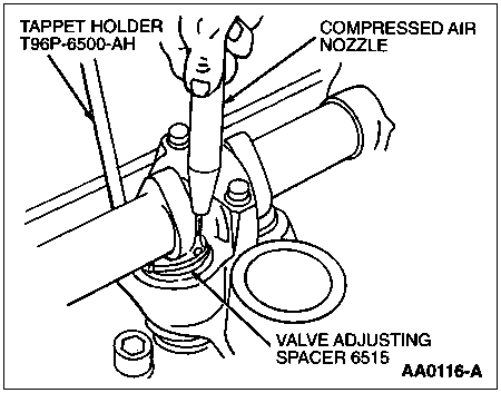1997 Ford Taurus - Service illustration showing valve adjusting spacer removal using tappet holder tool and a compressed air nozzle.