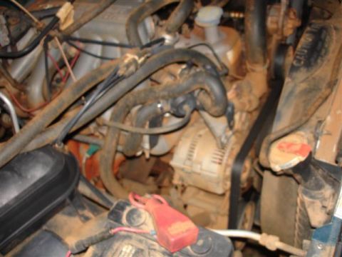 1996 Ford F-150 - The engine bay is heavily covered in dirt and grime, obscuring many details.