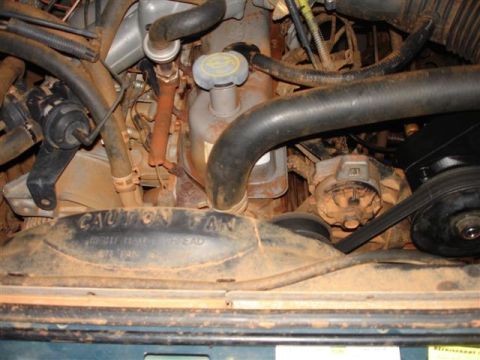 1996 Ford F-150 - Close-up of an engine bay, focusing on the fan shroud and surrounding mechanical parts.