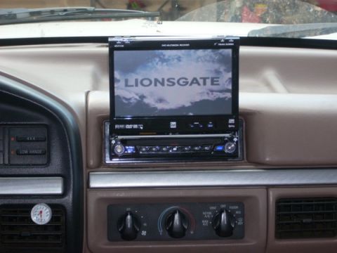 1992 Ford Bronco - Dashboard of a 1992 Ford Bronco an aftermarket entertainment system with a flip-out screen.