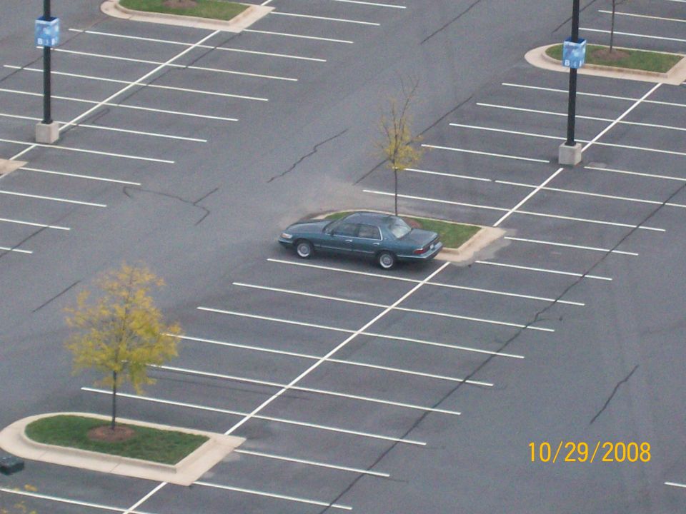 Green sedan parked in an empty parking lot. Date stamp reads 10/29/2008