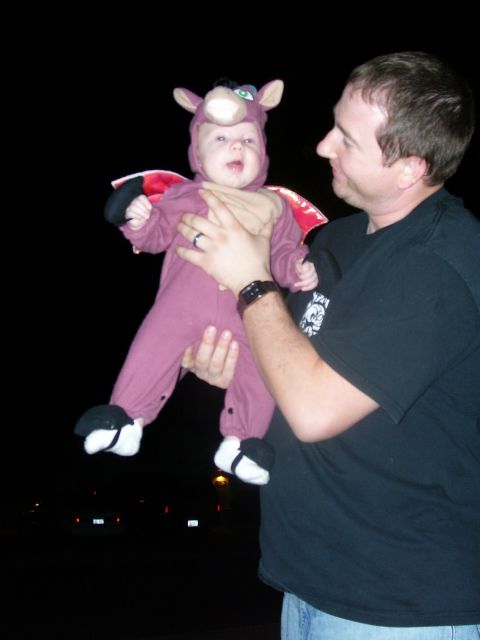 1991 Ford Bronco - A man holds a baby dressed in a purple costume with wings and ears.