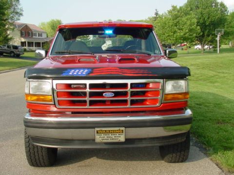 1992 Ford Bronco - This 1992 Ford Bronco is shown from the front, a custom flag decal on its hood.