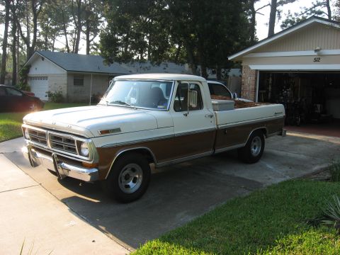 1972 Ford F-100 - A classic Ford pickup truck is parked in front of a suburban garage.