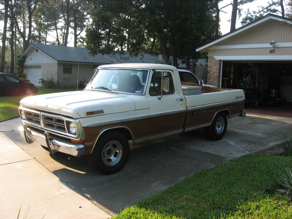 Two-tone brown and white Ford pickup truck parked in a driveway