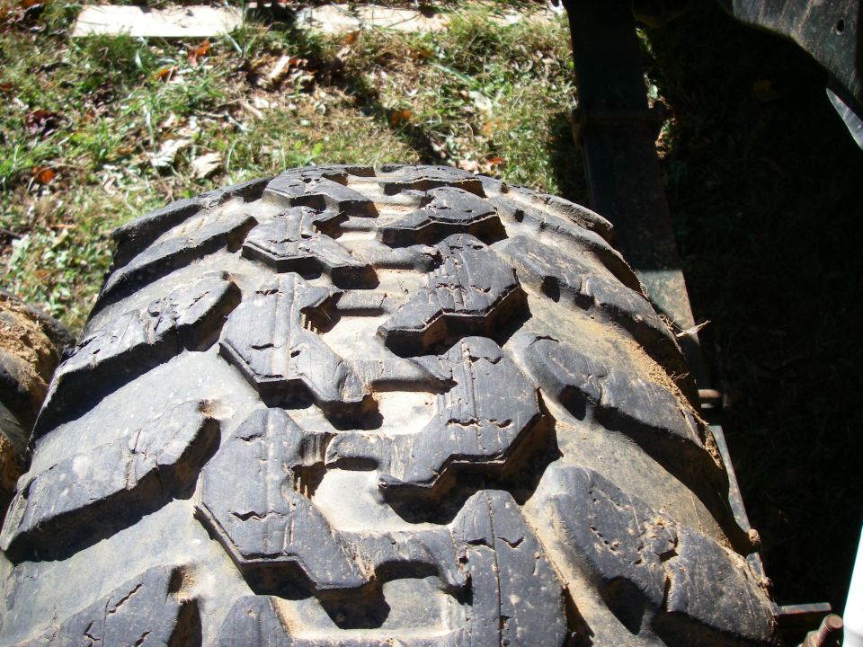 Close-up of a worn off-road tire with aggressive tread pattern