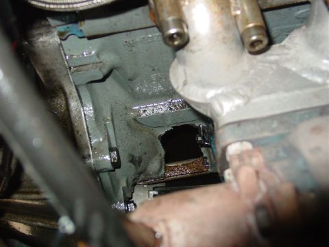 1986 Ford Mustang - Engine block shows significant damage with a large hole, revealing internal components and rust.