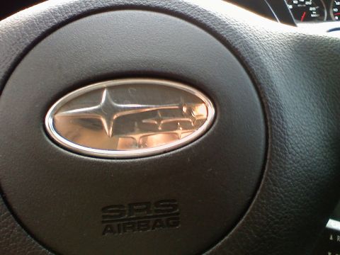 2007 Subaru Impreza - Close-up of the steering wheel in a 2007 Subaru Impreza, showing the SRS Airbag and Subaru emblems.