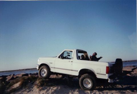 1992 Ford Bronco - A white 1992 Ford Bronco with occupants enjoys a day by the water.
