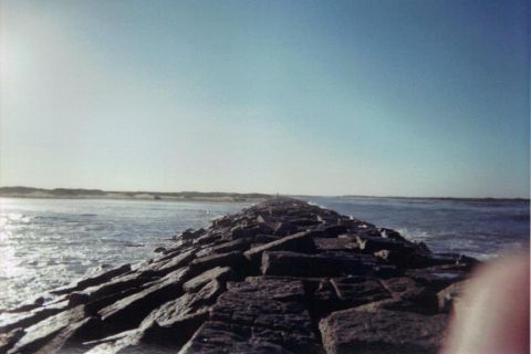 1992 Ford Bronco - A long rock jetty leads out into the ocean on a clear day.
