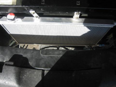 1996 Ford Thunderbird - Close-up view of a vehicle's radiator and fan shroud assembly.