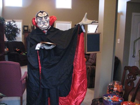 1991 Ford Bronco - A life-sized vampire decoration stands in a room, dressed in a cape and holding props.