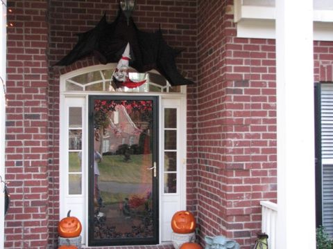 1991 Ford Bronco - A house entrance is decorated for Halloween with spooky figures and carved pumpkins.