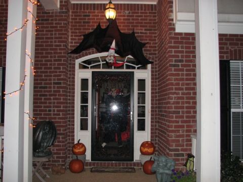 1991 Ford Bronco - A brick house porch is decorated for Halloween with pumpkins and a large bat hanging over the door.