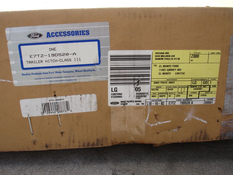 Box with Ford accessories label for a trailer hitch, part number E7TZ-19D520-A, and shipping labels