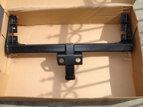 1992 Ford F-350 - A black trailer hitch is shown inside its cardboard packaging.