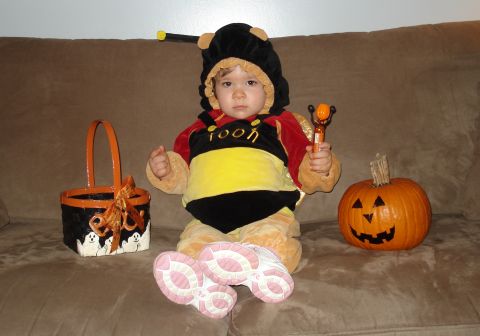 2000 Ford Crown Victoria - A child dressed as a bee sits on a couch with a Halloween basket and a carved pumpkin.