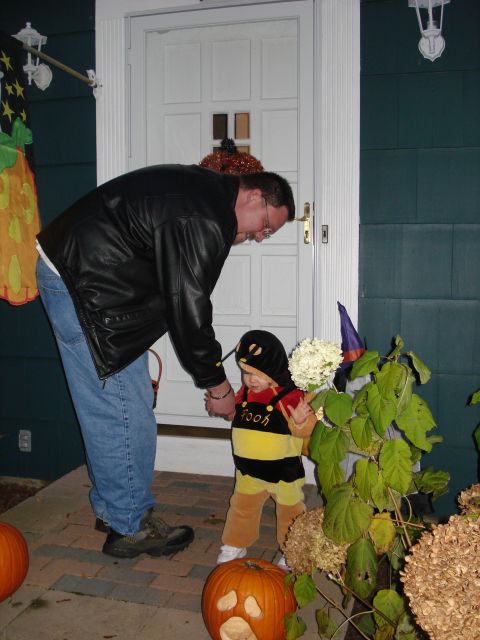2000 Ford Crown Victoria - A father helps his child, dressed as Winnie the Pooh, on Halloween night by the front door.