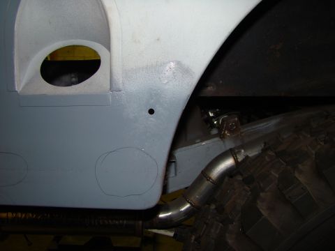 1948 Jeep Wrangler - Close-up view of a vehicle's body panel and exhaust system, with markings indicating body work.