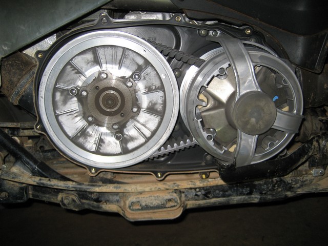Opened ATV CVT case showing primary and secondary clutches with cogged belt