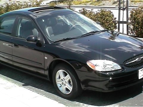 2002 Ford Taurus - This black 2002 Ford Taurus sedan features a sunroof and is captured in a 3q front view.