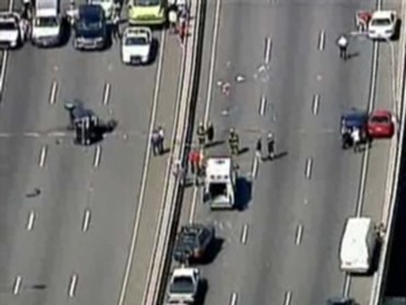 1993 Ford Bronco - Highway accident scene with multiple vehicles involved and emergency responders on site.