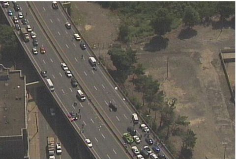 1993 Ford Bronco - An aerial view captures a highway accident scene with numerous vehicles, debris scattered, and people attending to the situation.