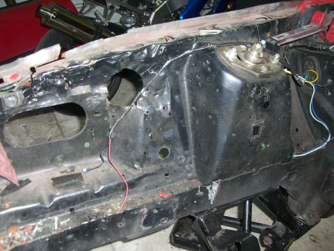 1988 Ford Bronco - Close-up view of the engine bay frame rail and suspension mounting point.