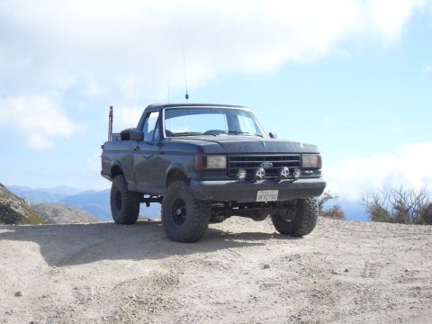 1990 Ford Bronco - This 1990 Ford Bronco is equipped for off-road adventures with its lifted suspension, large tires, and extra lighting.