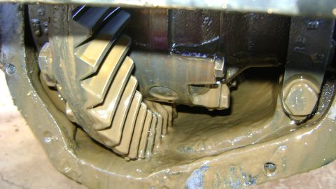 1986 Ford Bronco - The differential gears are covered in a thick, muddy lubricant, suggesting a need for maintenance or inspection.