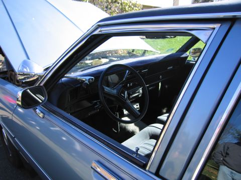 2001 Ford Crown Victoria - Interior view of a blue car with the hood open, showing the dashboard and steering wheel.
