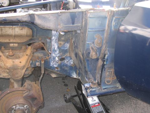 2001 Ford Crown Victoria - The vehicle's frame shows significant rust and damage, indicating extensive repair needs.