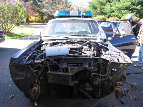 2001 Ford Crown Victoria - This police car's front end is disassembled, revealing the engine and radiator components.