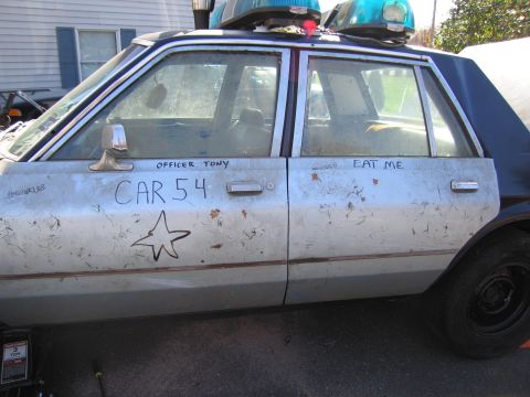 2001 Ford Crown Victoria - This vehicle has graffiti including 'CAR 54' and 'OFFICER TONY' on its side.